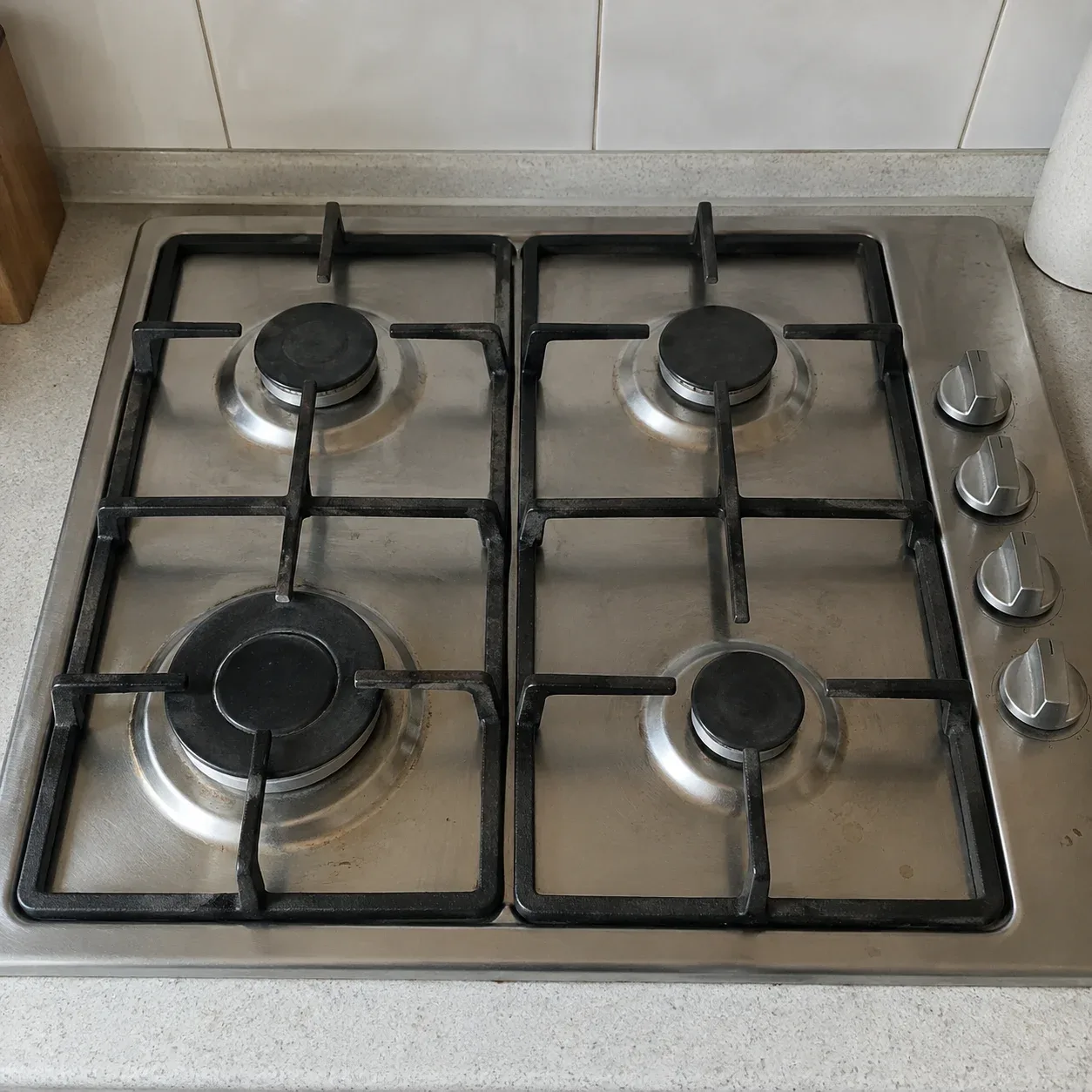 Stovetop with burners exposed for repair